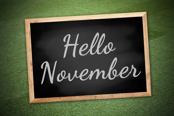 Hello November on chalk board and green field background and tex — Stockfoto