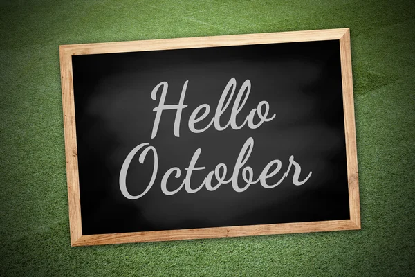 Hello October on chalk board and green field background and text — Stock Photo, Image