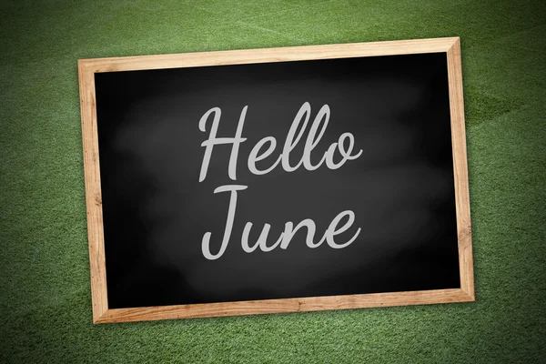 Hello June concept on chalk board and green field background and texture — Stock Photo, Image