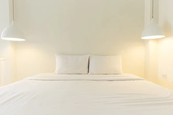 Bed in a hotel room at night — Stock Photo, Image