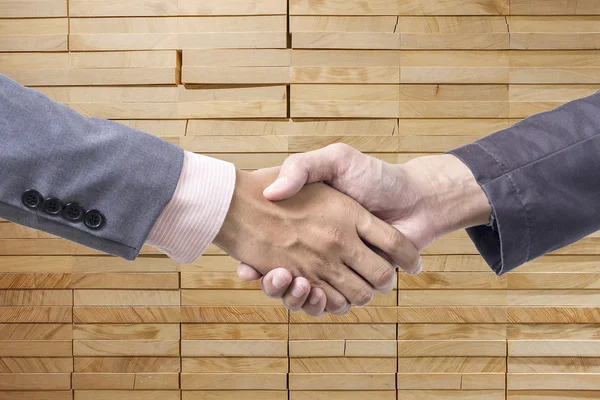 Business handshake on wood background — 图库照片