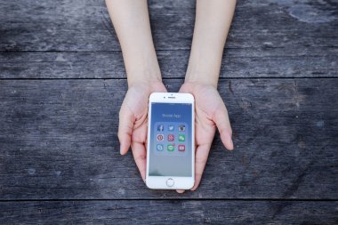 Chiang Rai, Tayland - 13 Eylül 2015: Apple iphone göstermek tüm popüler sosyal medya simgeler smartphone aygıt ekran arka planda tutan kadın.