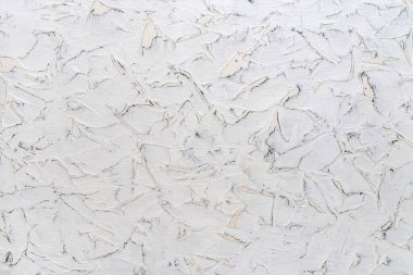 Farklı şekillerde lekeleri olan bir yüzeyde çatlak beyaz boya dokusu. Üzerinde gri çizikler olan beyaz bir duvar. Soyut inşaat arka plan tasarım elemanı. Ön görünüm.