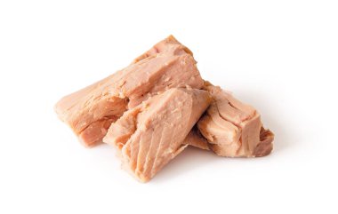 Beyaz arka planda izole edilmiş konserve ton balığı filetosu parçaları. Düşük kalorili diyetler ve sağlıklı beslenme için deniz ürünleri olarak korunur. Yiyecek tasarımı için ton balığı eti parçası. Makro. Ön görünüm.