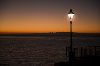  Illuminated street lamp during the sunset clipart