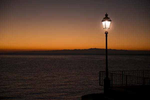 Illuminated street lamp during the sunset — Stock Photo, Image