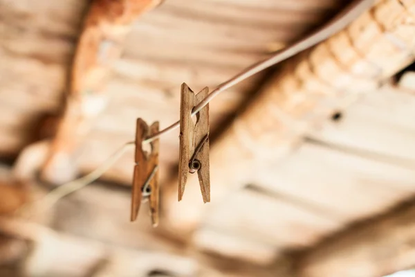Wooden clothespins on rope