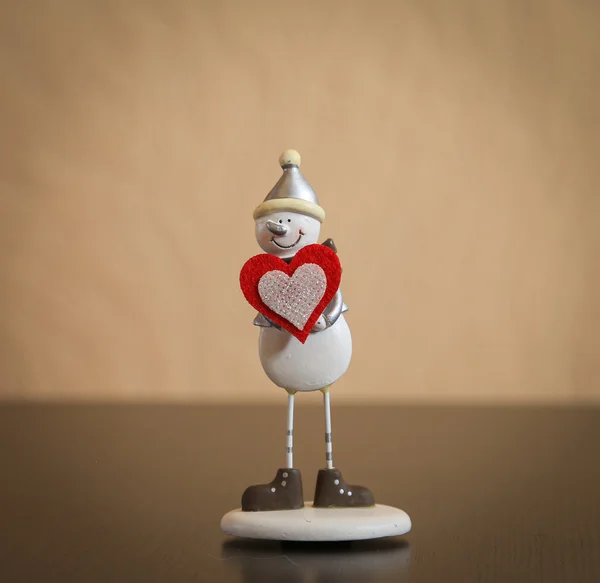Snowman with red heart — Stock Photo, Image