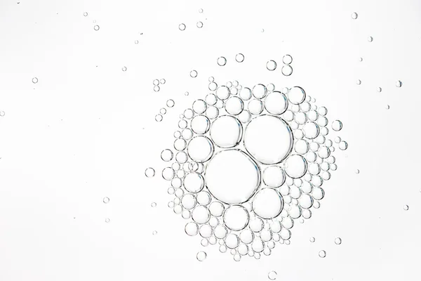 Oil drops in water on a white background — Stock Photo, Image
