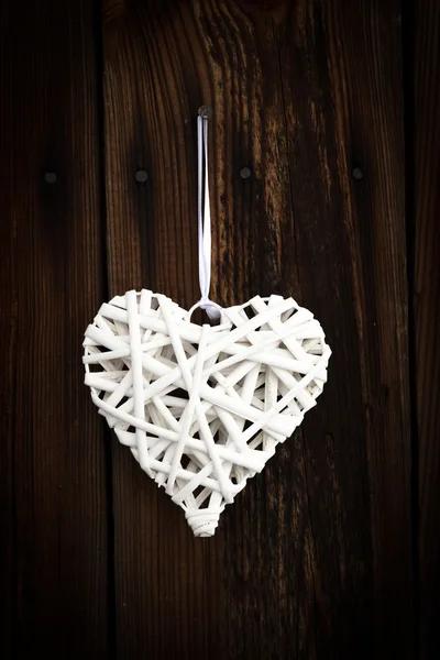 White wicker heart on wooden background — Stock Photo, Image