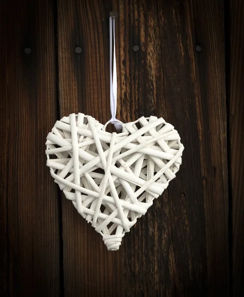 White wicker heart on wooden background — Stock Photo, Image