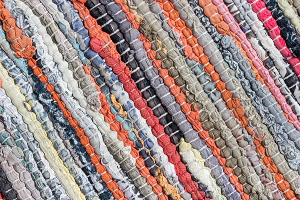 Carpet striped made from little pieces of colorful woven cotton Stock Photo