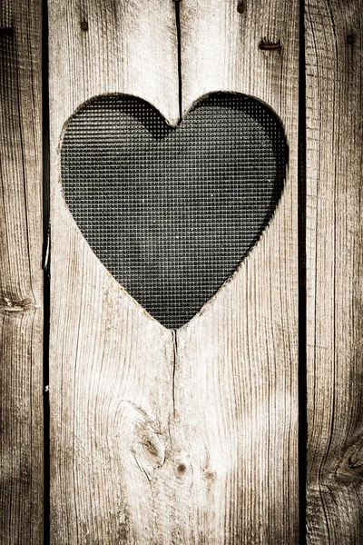 La porte en bois avec le coeur. Contexte — Photo