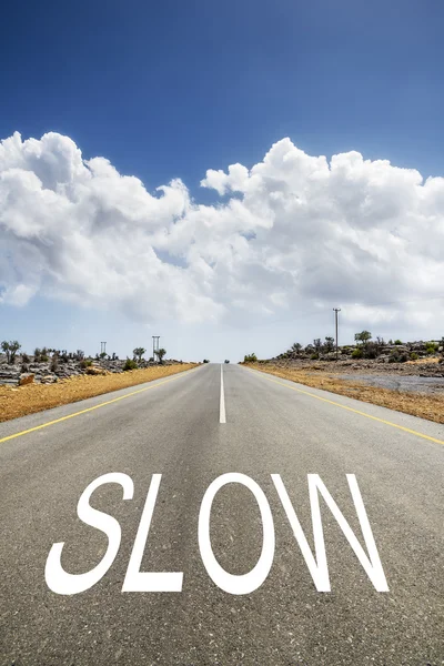 Road with text SLOW — Stock Photo, Image