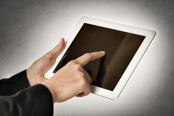 Business woman points tablet computer — Stock Photo, Image