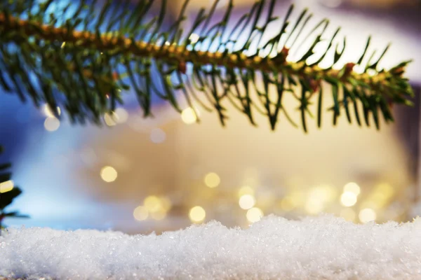 Branch and artificial snow with bokeh lights — Stock Photo, Image