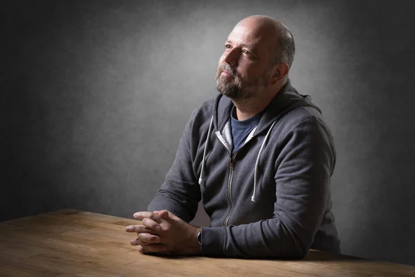 Man sitting on table — Stock Photo, Image