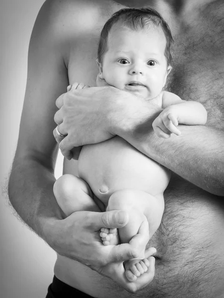 Baby girl in a father's arms — Stock Photo, Image