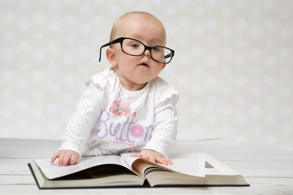 Funny baby girl reading a book — Stock Photo, Image