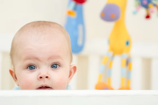 Baby girl in her crib — Stock Photo, Image