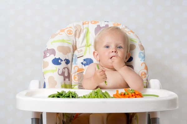 Bebê menina comer alimentos crus — Fotografia de Stock