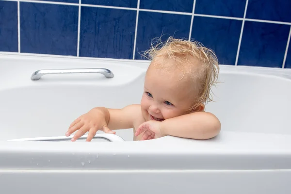 Baby girl smiles in the bathroom — Stock Photo, Image