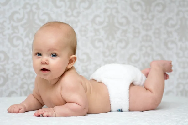 Baby girl lying on the belly — Stock Photo, Image