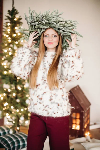 Beautiful woman in Christmas wreath on head. — Stock Photo, Image