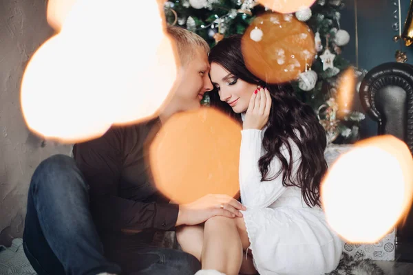 Beautiful couple in love celebrates new year together. picture with macro lights — Stock Photo, Image