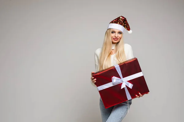 Beautiful young lady holds her big christmas present, picture isolated on white background — 스톡 사진