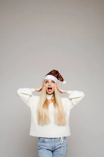 Beautiful young woman with blonde hair poses on camera touches her hair in shock, picture isolated on white backgroung — 스톡 사진