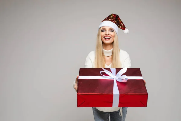Pretty girl giving Christmas present to camera. — 图库照片