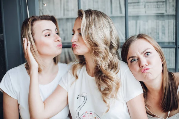 Drie mooie beste vrienden verheugen zich samen en knuffelen elkaar — Stockfoto