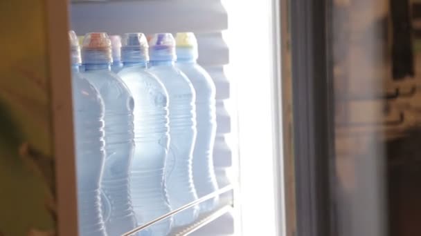 Woman take bottle of cold fresh mineral water — Stock Video