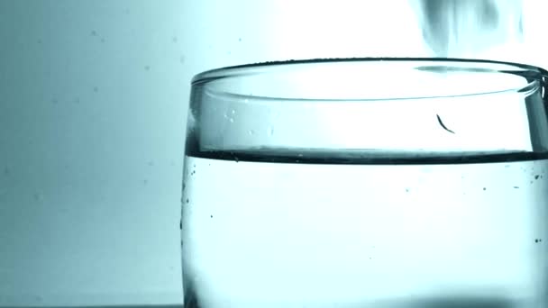 Ice cube fall into a glass — Stock Video