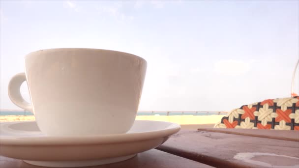 Cup of coffee near the ocean — Stock Video