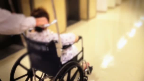 Paziente donna in sedia a rotelle in ospedale — Video Stock