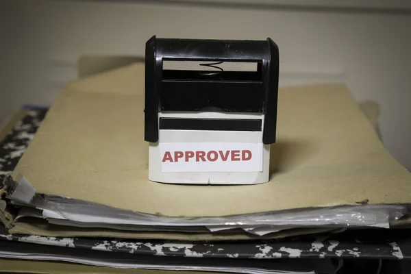 Approved stamp on a big folder of paperwork — Stock Photo, Image