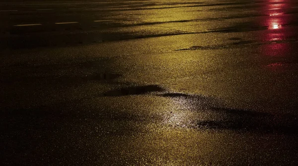 Wet asphalt road after the rain. Asphalt background. Asphalt