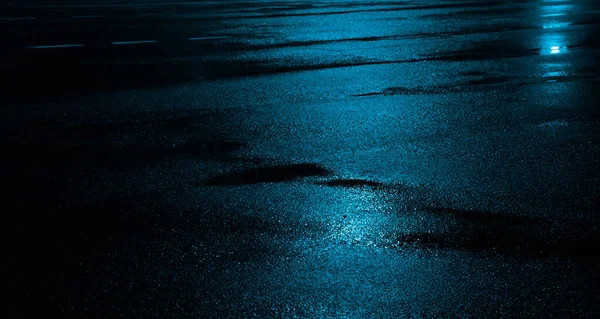 Wet asphalt road after the rain. Asphalt background. Asphalt perspective.  Background and texture. Sun reflection Stock Photo