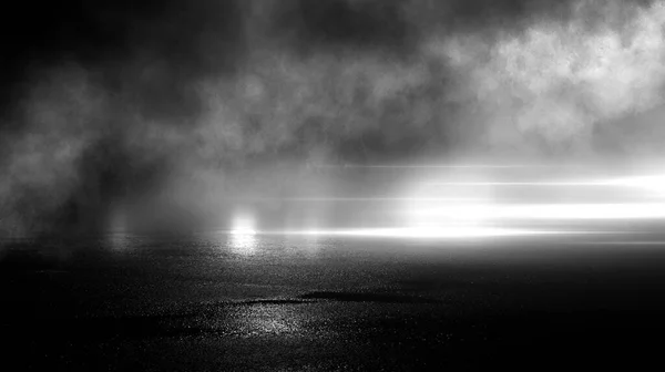 Dark street, black background, glare of light on the wet asphalt. Rays and lines, smoke. Dark city street.