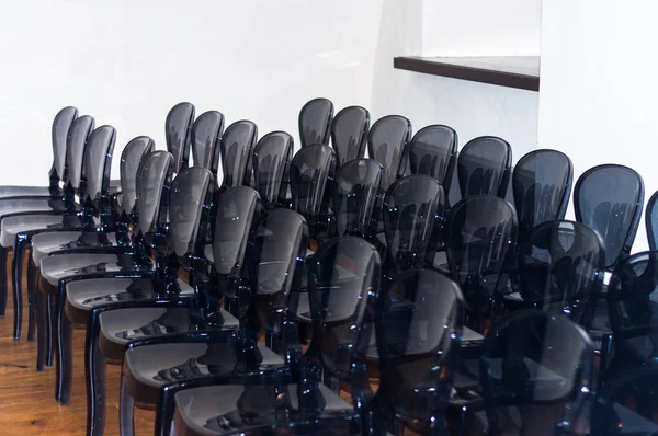 Row of plastic black chairs