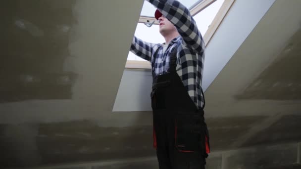 新的隔热干墙阁楼安装聚氯乙烯窗户的技工 建筑工人 — 图库视频影像