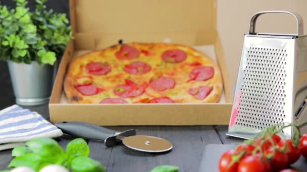 带有配料的热披萨和黑色质感背景的披萨切刀 顶部视图 — 图库视频影像