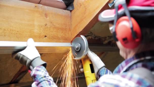 Man Fixing Metal Frame Using Angle Grinder Attic Ceiling Covered — Stock Video