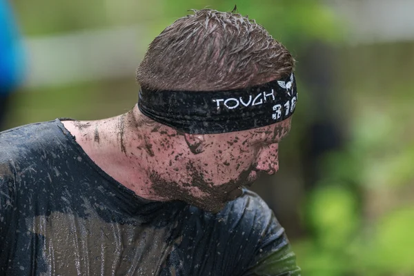 Dirty face at the muddy net trap in Tough Viking obstacle course