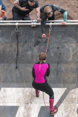 Woman climbing at Tough Viking obstacle course around Stockholm 