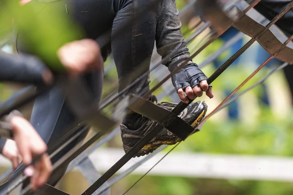 Closeup of feet climbing the A- frame at Tough Viking obstacle c — Zdjęcie stockowe