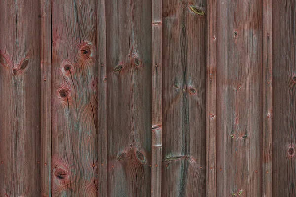 Tablones pintados de rojo oscuro fuera de un granero — Foto de Stock