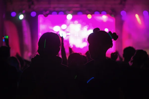 Silhouettes of happy people infront of the stage at the Color Ru — Stock Photo, Image